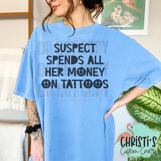 Suspect spends all her money on tattoos